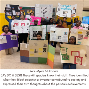 6th Graders holding science projects.